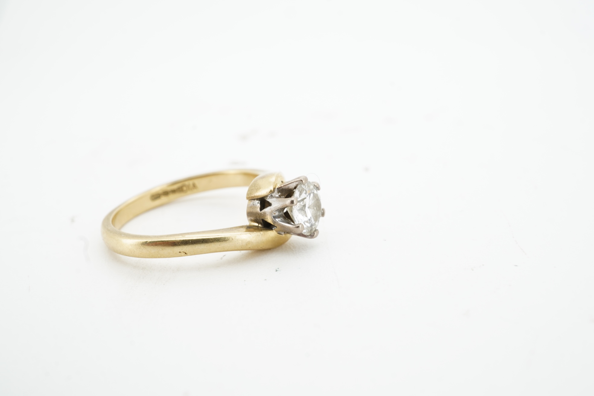 A diamond solitaire ring, claw-set with a brilliant-cut diamond weighing approximately 0.50 carats, to an symmetrical 18ct gold mount, size I, British hallmarks, gross weight approximately 3 grams